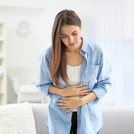 Femeie cu durere de burtă. Durerile abdominale sunt printre primele simptome de cancer colorectal