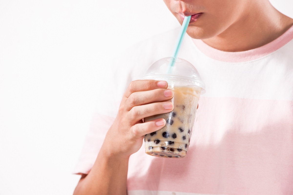 Bărbat care bea un bubble tea din pahar de plastic